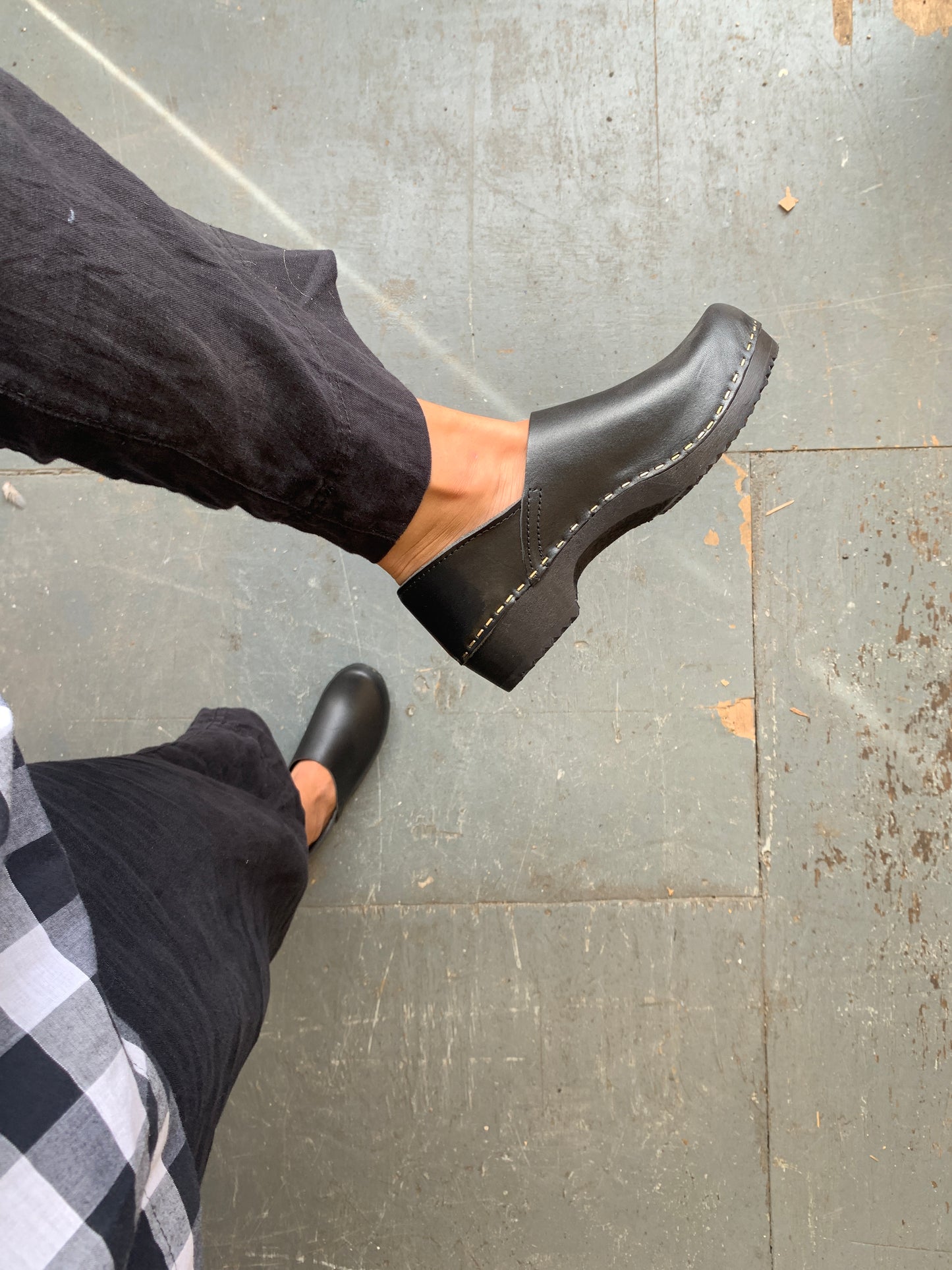 Black covered back swedish clogs with black base