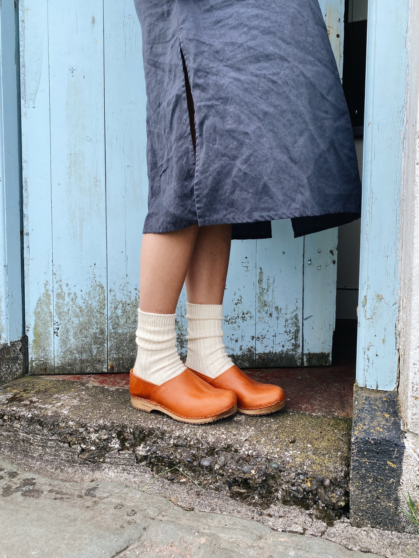 Cumin tan swedish clogs with a low wooden base and covered back