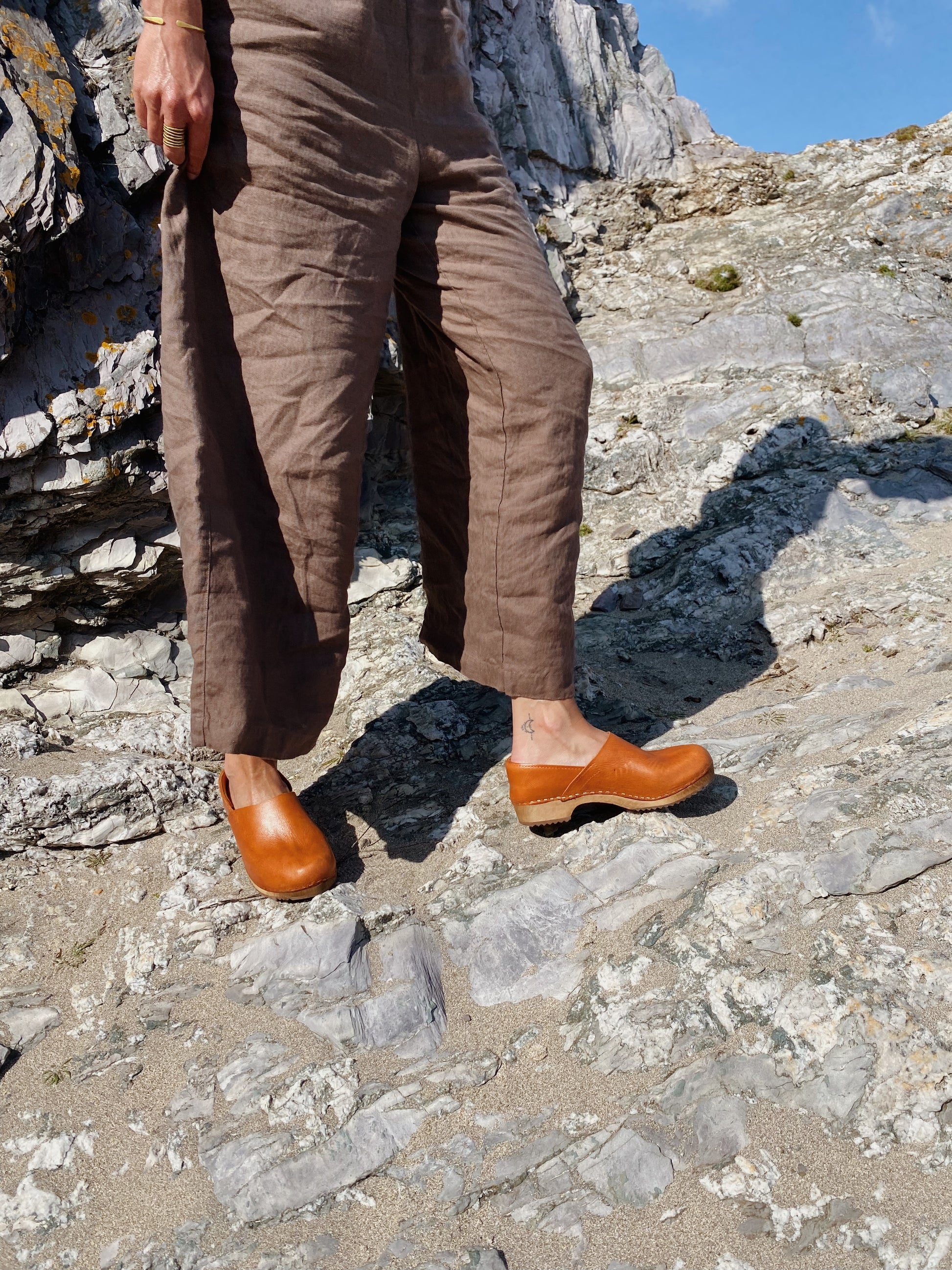 Cumin tan swedish clogs with a low wooden base and covered back