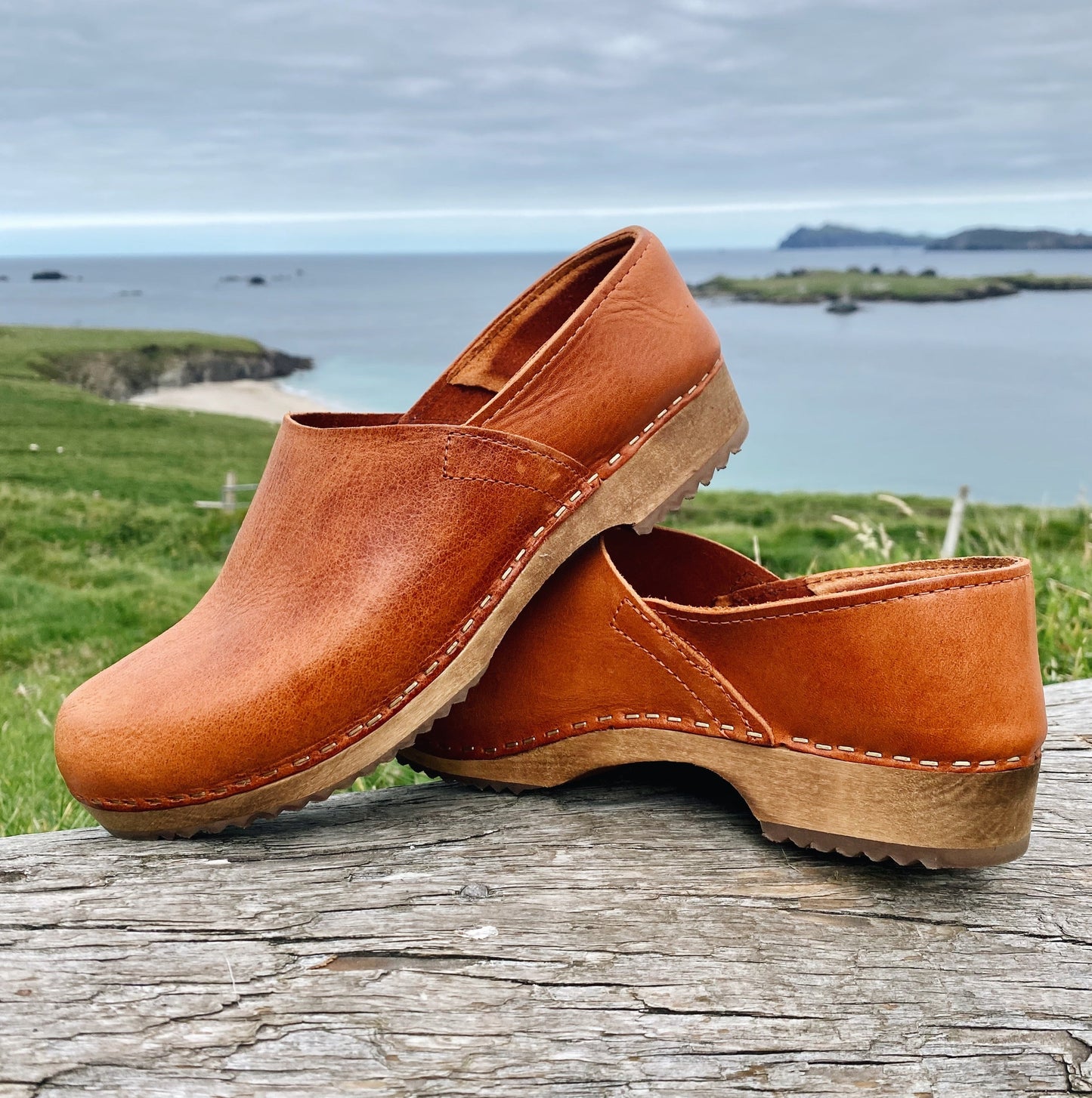 Cumin tan swedish clogs with a low wooden base and covered back